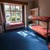 Kiwi's Nest Budget Accommodation & Backpackers bunk room with window seat in Dunedin
