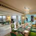 ITC Gardenia, a Luxury Collection Hotel, Bengaluru dining room with long set table and peacock mural