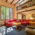 Mountainside Villas at Massanutten in McGaheysville living room with stone fireplace, red sectional and loft