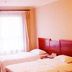 Binhai Mingzhu Hotel Beijing guest room with two single beds and window with curtains