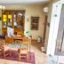 Hotel Colonial de Santillana in Santillana del Mar lobby with tiled floor, desk, chairs and display cabinet