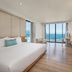 Tms Hotel Da Nang Beach room with king bed and floor-to-ceiling windows overlooking the ocean in Da Nang