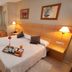 La City Estación Alicante guest room with twin beds, bedside lamps, desk and window light