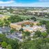 Mi Casa Hotel in Orlando with outdoor pool, parking lot, and city skyline view