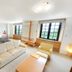 Colosseum Inn Tateshina guest room with sofa, two armchairs, and large windows in Tateshina