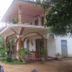 Thirumalai Park, Nilaveli: two-story hotel exterior with porch and balcony amid tropical greenery