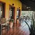 Posada Puerto Bemberg in Puerto Libertad: covered terrace with seating, tiled floor, and forest views