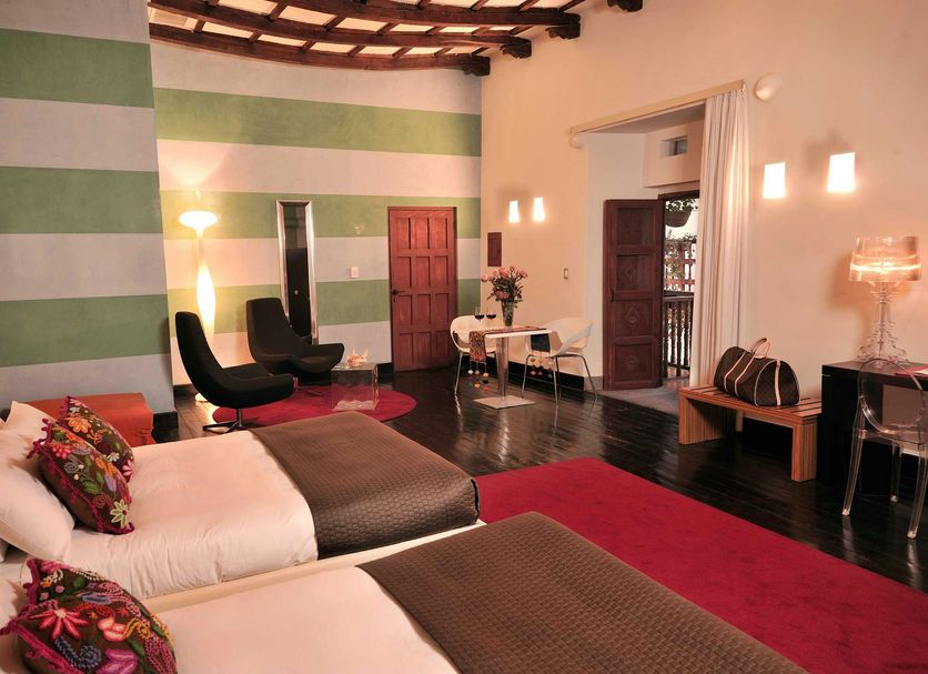 Casa Cartagena Boutique Hotel & Spa in Cusco, elegant guest room with twin beds, high ceiling and seating area