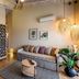 Anthemion Suites & Villas in Náfplio: stylish suite with sofa, kitchenette, woven pendant lights and balcony access