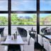 Minamisenri Crystal Hotel in Suita with dining tables by large windows overlooking greenery