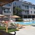Nur Apart in Marmaris with outdoor pool, sun loungers, and balconies beside a tree-lined terrace