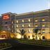 Hampton Inn & Suites Lake Wales hotel exterior at dusk with palm trees and lit windows