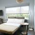Element Austin Round Rock guest room with bed, desk, wall-mounted TV, and large window in Round Rock