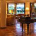 Hotel Santa Gilla in Capoterra lobby with a grand piano and views through glass doors