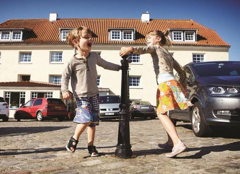 Danhostel Frederikshavn City in Frederikshavn, children near the hotel entrance and parked cars