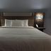Silver Beach Hotel in Saint Joseph guest room with a neatly made bed and wall lamps