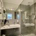 Zeitwohnhaus Suite-Hotel & Serviced Apartments bathroom in Erlangen with glass shower and wall-mounted sink
