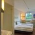 ibis budget Köln Leverkusen City guest room with twin beds, window view, and wall-mounted TV in Leverkusen