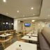 Dormy Inn Premium Shimonoseki Natural Hot Spring dining area with tables, chairs, and large windows