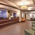 Holiday Inn Express & Suites Overland Park lobby with front desk and seating area