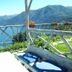Hotel Glavjc in Torno with lake-view terrace, bench, pineapples, flowers and mountain backdrop