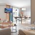 Résidence Pierre & Vacances Premium Haguna Biarritz apartment living area with sofa, dining table and TV