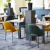 Fletcher Hotel Restaurant De Gelderse Poort in Ooij lounge with mustard and green chairs around dining tables