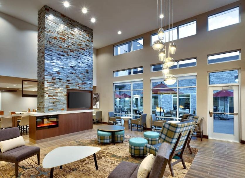 Residence Inn by Marriott Lubbock-University Area lobby with tall stone fireplace, seating area, and large windows