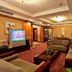 Chinflux Mandarin Hotel Dongguan lounge with sofas, coffee table, TV and warm ceiling lights
