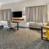 Hampton Inn & Suites Fort Worth/Forest Hill guest room with king bed, desk, TV, and large windows
