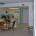 Islander Beach Resort in New Smyrna Beach: condo-style room with dining table, kitchenette, and ocean-view artwork