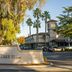 DoubleTree by Hilton Hotel Campbell - Pruneyard Plaza entrance sign with palm trees and parked cars