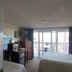 Windjammer BY The Sea Hampton guest room with two beds, desk, TV and balcony view