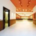 Hotel Club Astor in Ugento hallway with orange ceiling, white tile floor and open doors