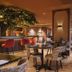 Van Der Valk Hotel Apeldoorn - De Cantharel lounge bar with tables, chairs and warm ambient lighting