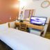 Toyoko Inn Izumo-shi Ekimae in Izumo: compact twin room with desk, TV and wall clock