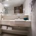 Petit Rio Hotel Rio de Janeiro bathroom with glass shower, double sink vanity, and towels