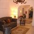 Masseria Magli Resort in Martina Franca lobby with patterned sofa, lamp, chandelier and archway