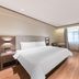 Hanting Nanshan Avenue Shenzhen room with king bed, desk, window and wall-mounted TV