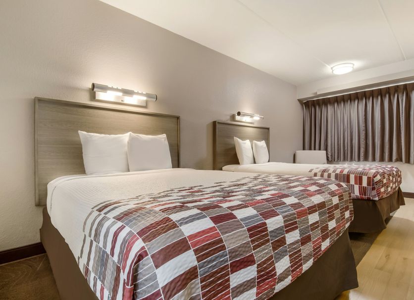 Red Roof Inn Detroit - Farmington Hills room with two double beds and window curtains