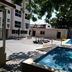 Hotel Graham Villahermosa courtyard with outdoor pool, lounge chairs, and shaded trees