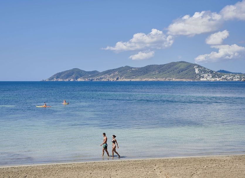 Beachfront view at Iberostar Selection Santa Eulalia Ibiza in Santa Eulària des Riu with calm sea and mountains