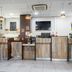 B&B HOTEL Maubeuge-Louvroil lobby reception desk in Louvroil with wood-paneled counter and potted plant