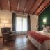 Hotel-Apartamento Rural Atxurra in Bermeo guest room with wooden ceiling, green accent wall, and double bed