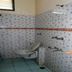 Hotel Sunil Krishna bathroom in Tirupati with toilet, shower fixtures and patterned tile walls