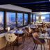 The Manor House At Celtic Manor in Newport, dining room with city views through floor-to-ceiling windows