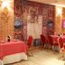 Dining room at Hospedium Hotel Vittoria Colonna in Medina de Ríoseco with red tables and chairs