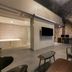 Daegu Dongdaegu H Hotel lobby lounge with staircase, wall-mounted TV, and bathtub area in Daegu