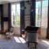 La Divine Comédie-Suites Deluxe in Avignon: suite with tall windows, sitting area, and ornate cabinet