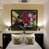 Garni Hotel Zen in Niš bedroom with double bed, wall art, and bedside lamps